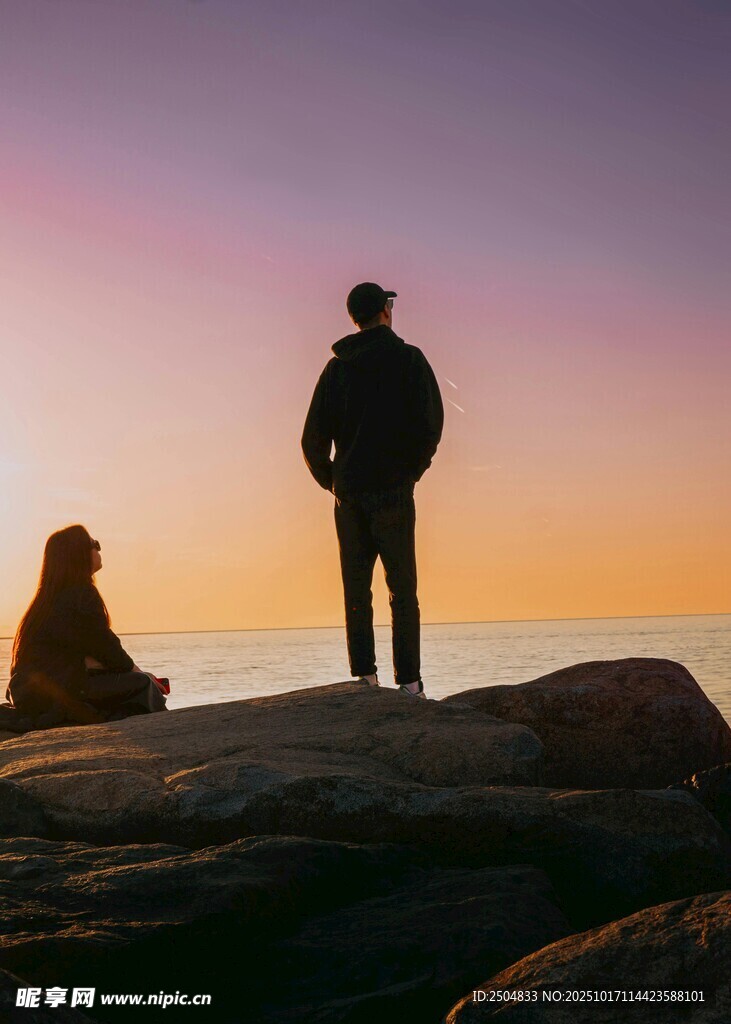 夕阳下的两人海边静谧时刻