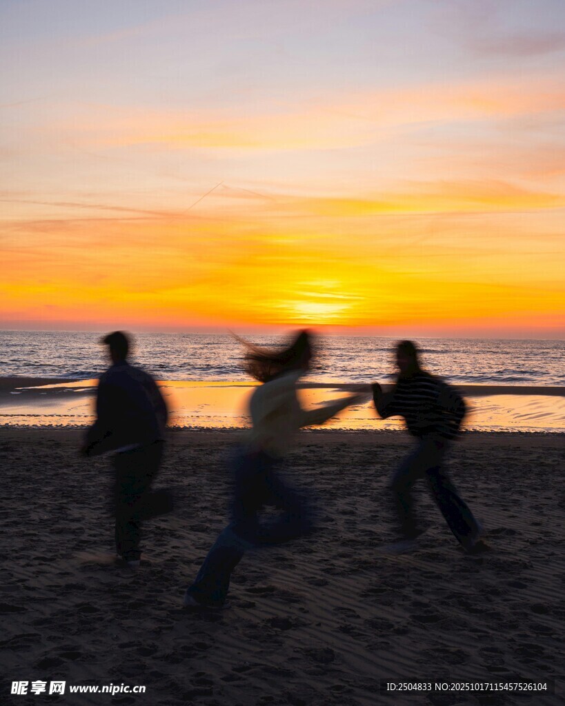夕阳下海边嬉戏的人们