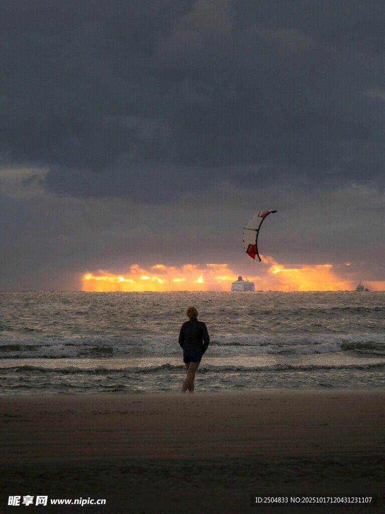 海边黄昏下的风筝冲浪者