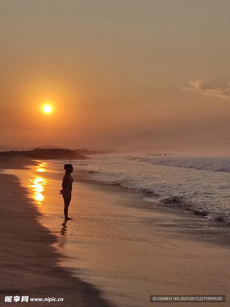 夕阳下海边漫步的身影