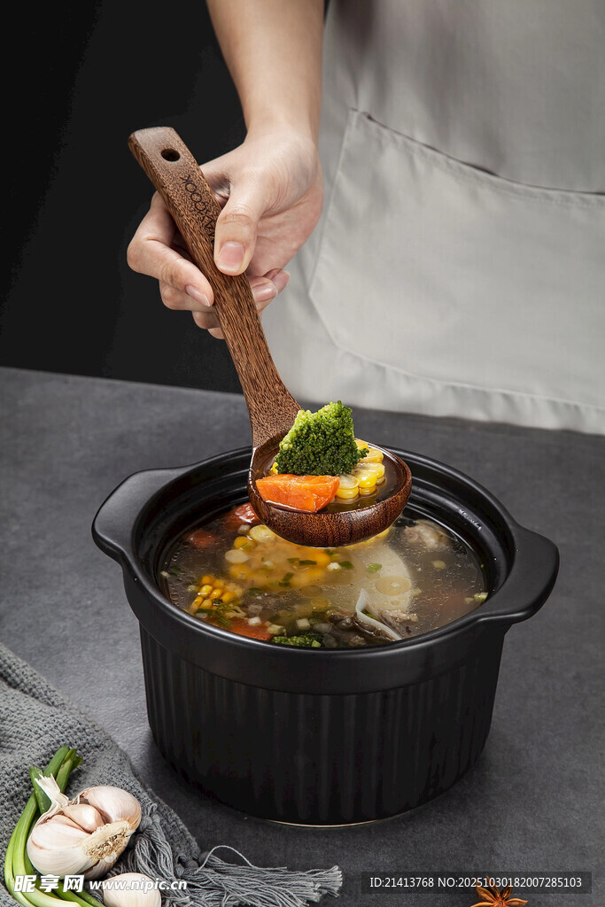 手持木铲烹饪锅中美食