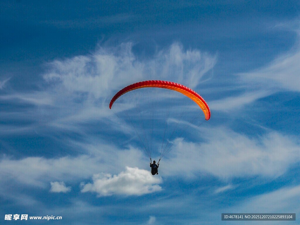 蓝天中滑翔的彩色滑翔伞