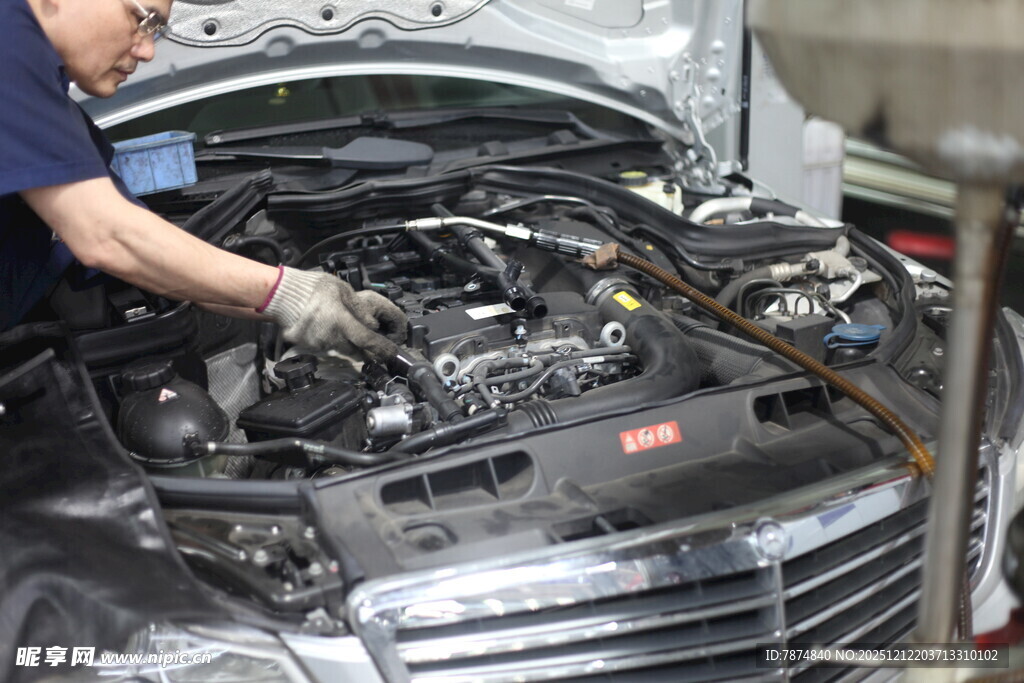 工人专注检修汽车发动机