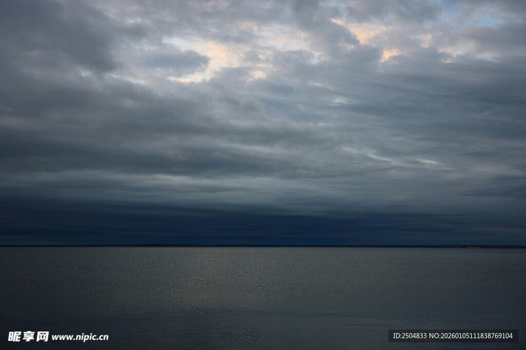 乌云笼罩下的平静湖面