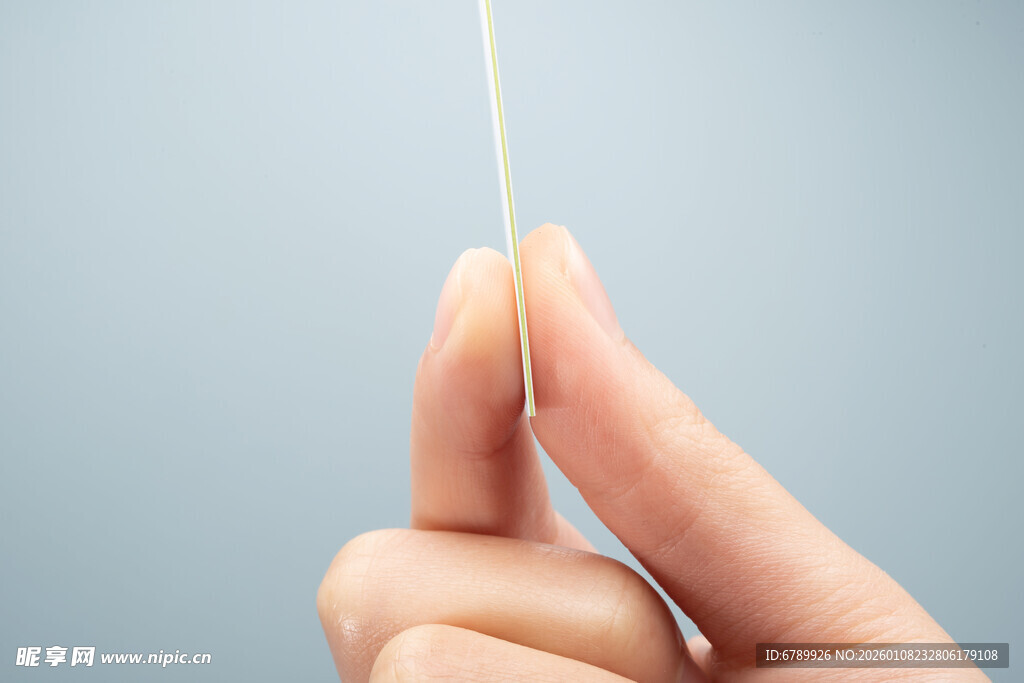 手指捏着一张薄卡片 