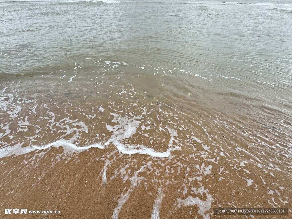 海边沙滩上的白色浪花