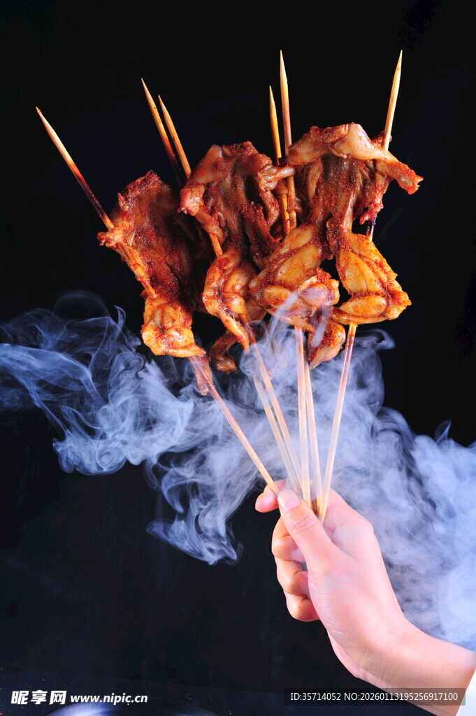手持冒烟美味烤牛蛙串