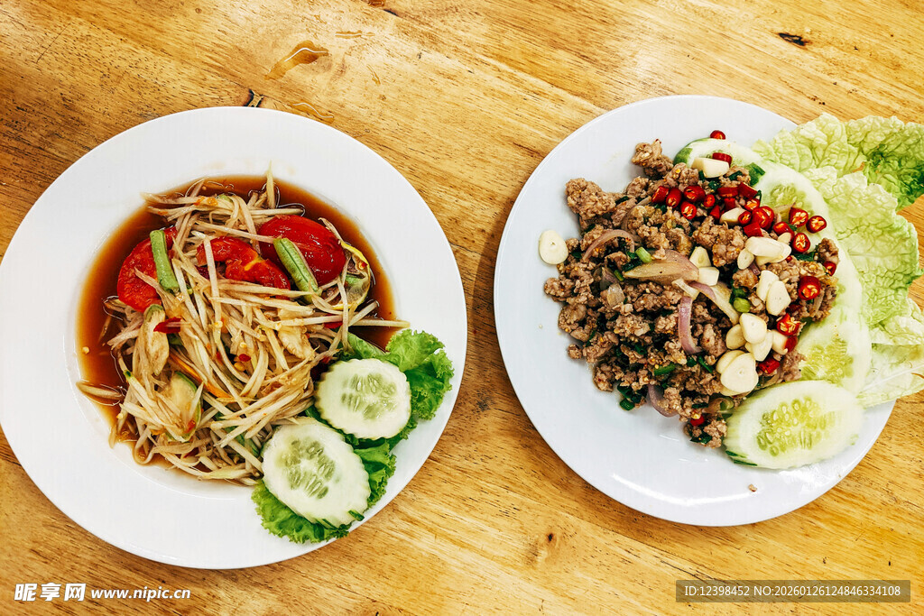 两盘美味佳肴摆于木桌