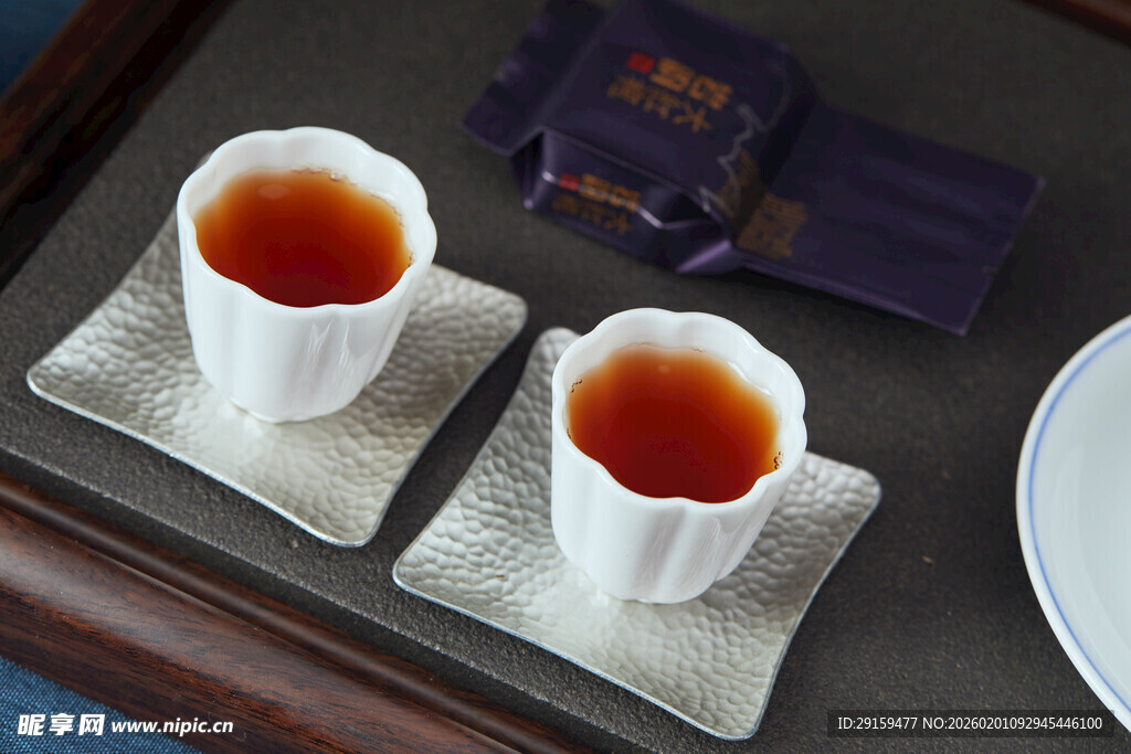 两杯热茶置于精致杯垫上