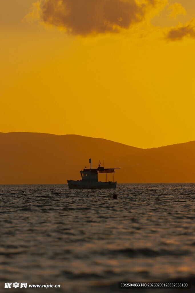 夕阳下海上的孤独船只
