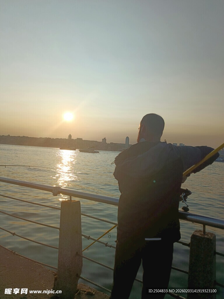 夕阳下的江边人物剪影