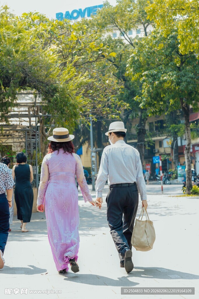 老夫妻漫步于林荫街道