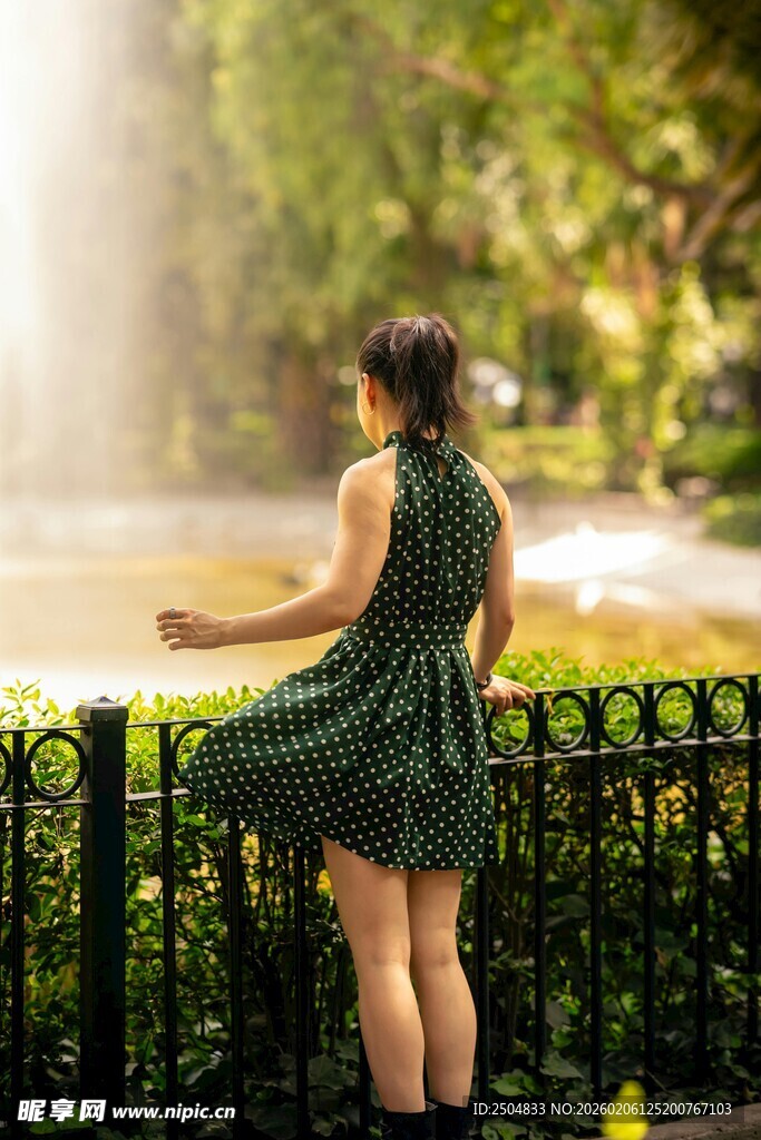 女孩赏喷泉 裙随风飘动