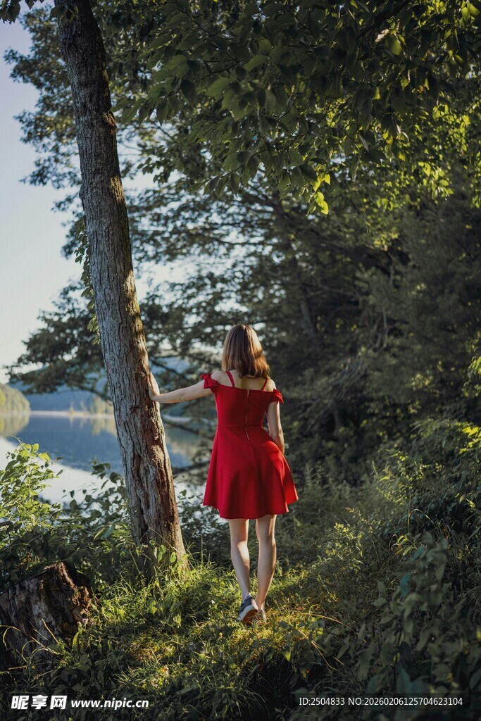 红衣女子林间眺望远方