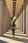 女子漫步于柱廊之间