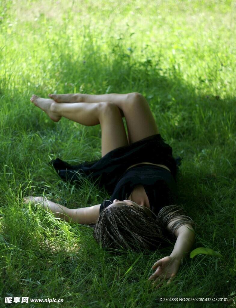 女子休憩于葱郁草地上
