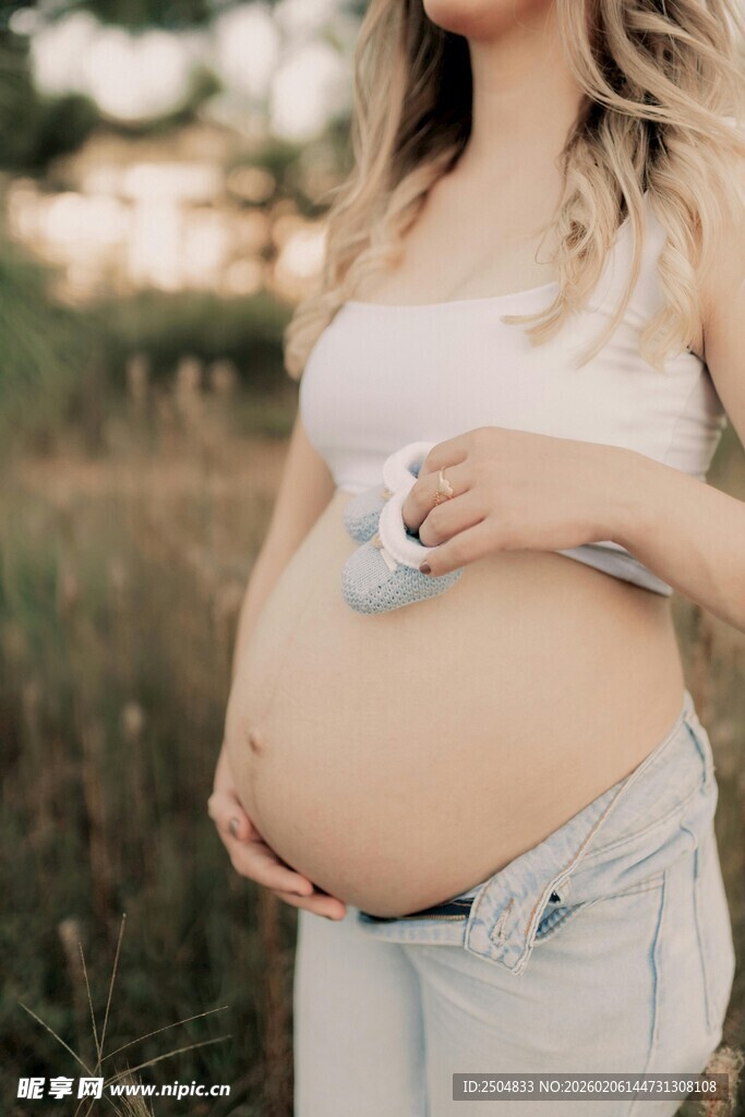 孕妇户外轻抚隆起的孕肚