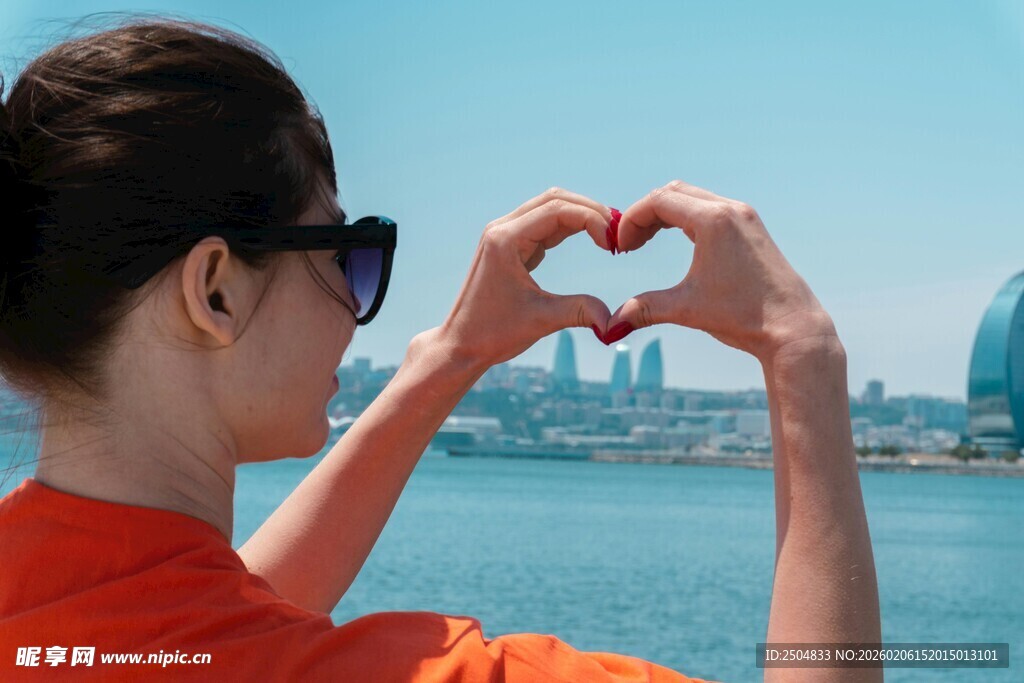 女子海边比心赏景