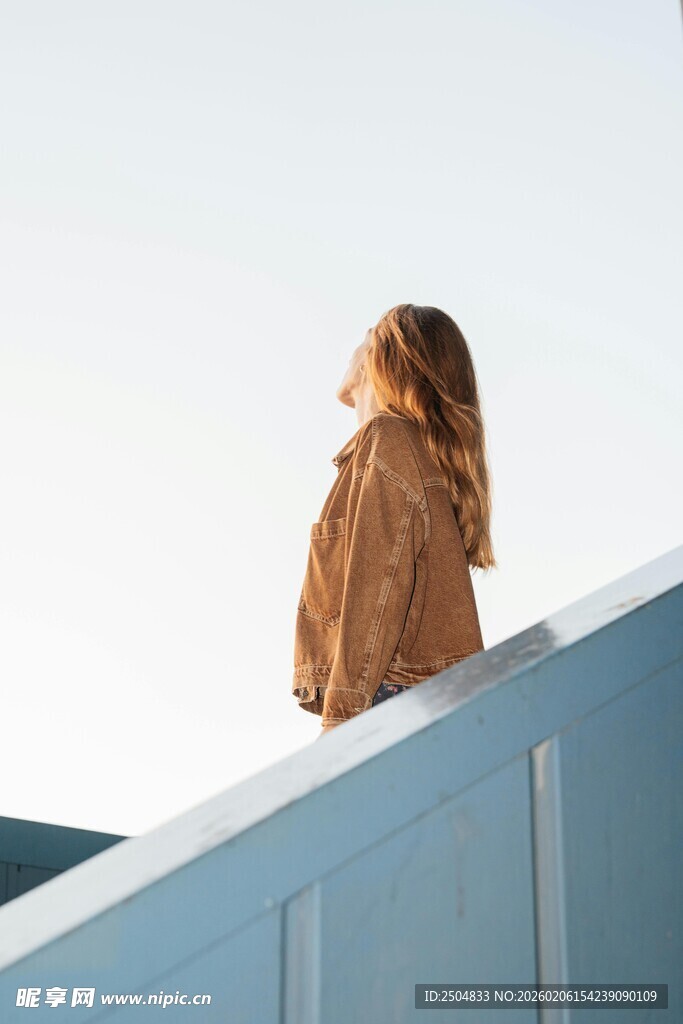 女子立于高处眺望远方