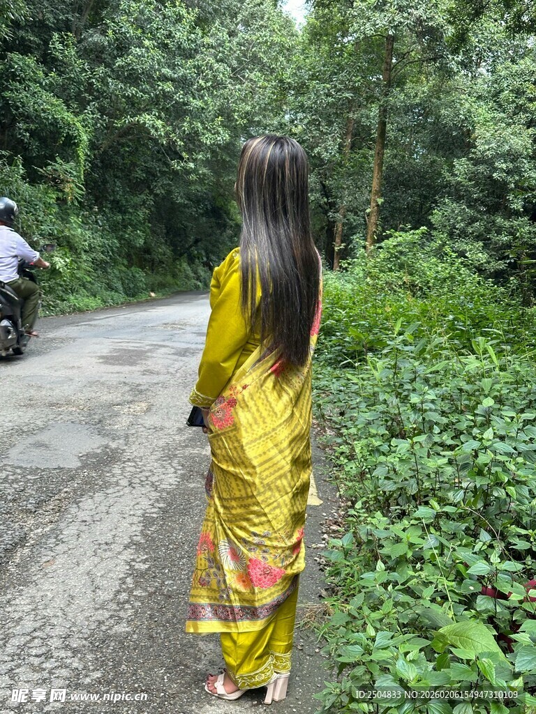 身着黄衣女子漫步林间小道