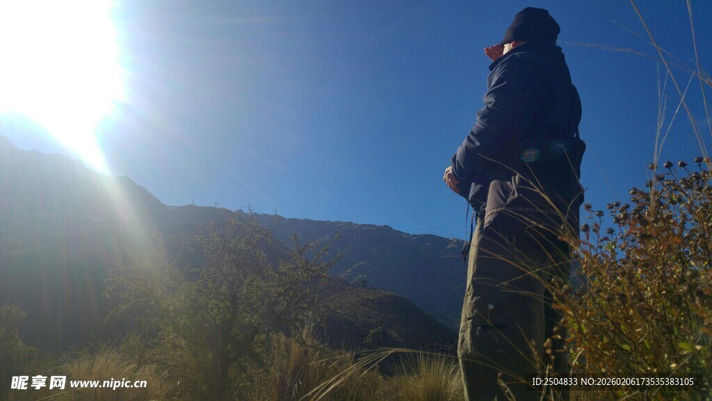 登山者逆光眺望远方