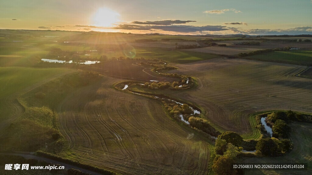 夕阳下广袤田野的航拍景