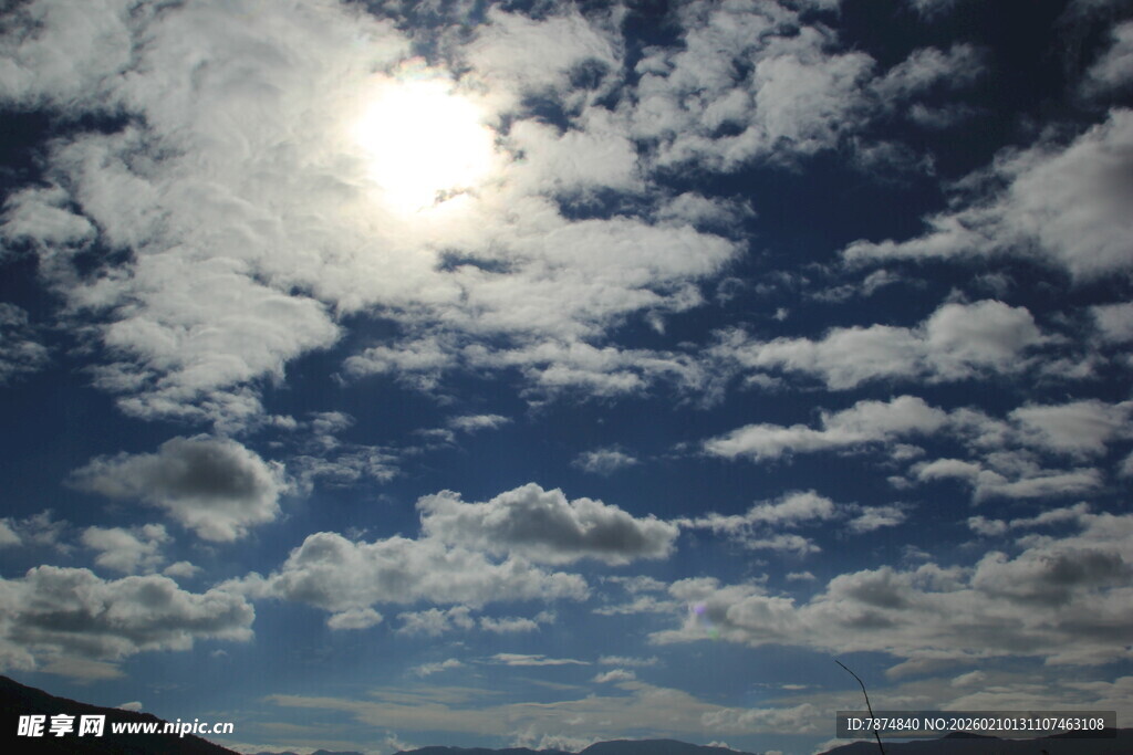 晴朗天空下的阳光与云朵