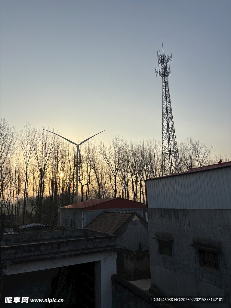黄昏下的风车与通信塔