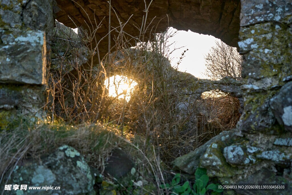 破旧石墙洞中的温暖光线
