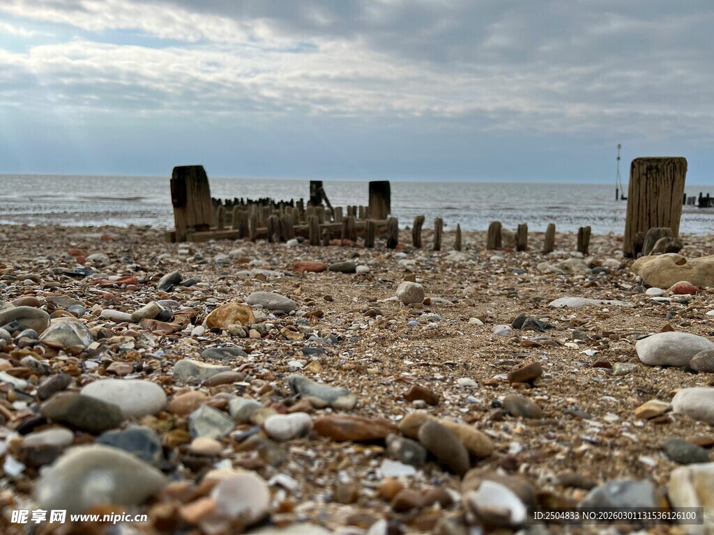 海边残旧木桩与碎石景观