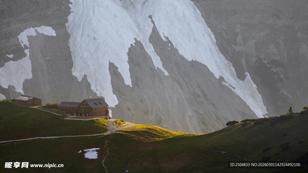 山间小屋映于雪山草地