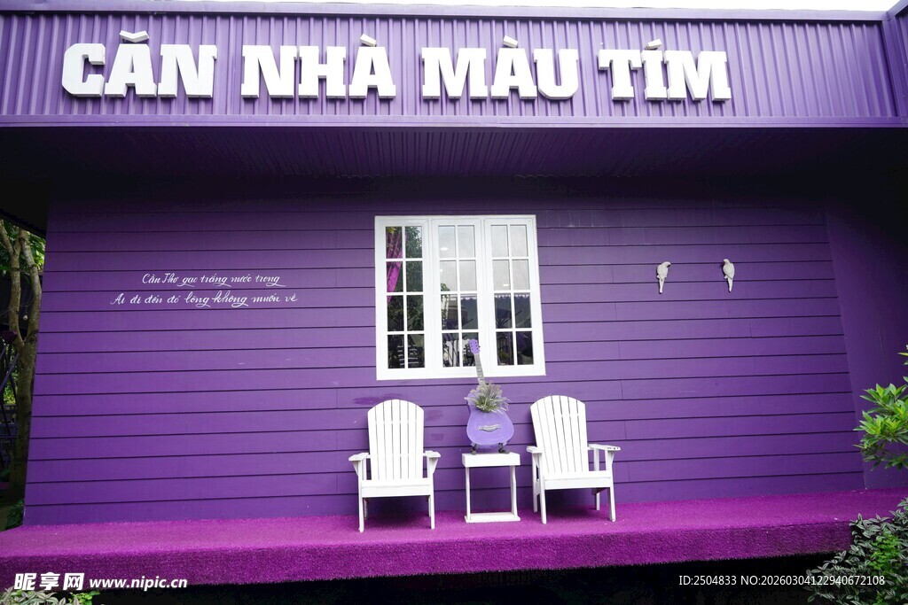 紫色小屋前的两把白椅子