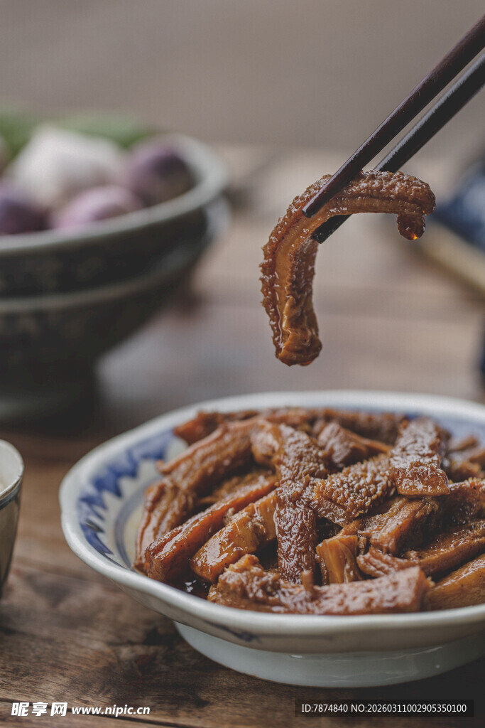 筷子夹起的美味卤鸭掌