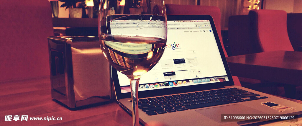 夜晚桌上的电脑与酒杯