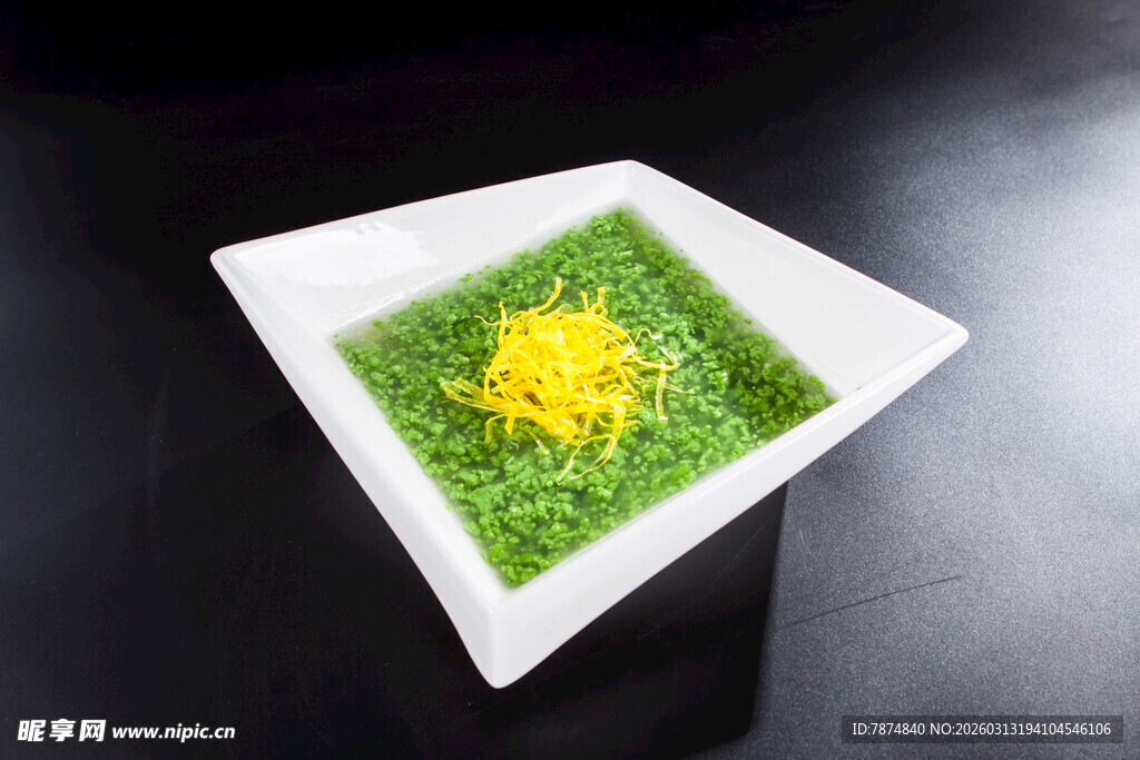 绿色摆盘上的黄色精致菜品