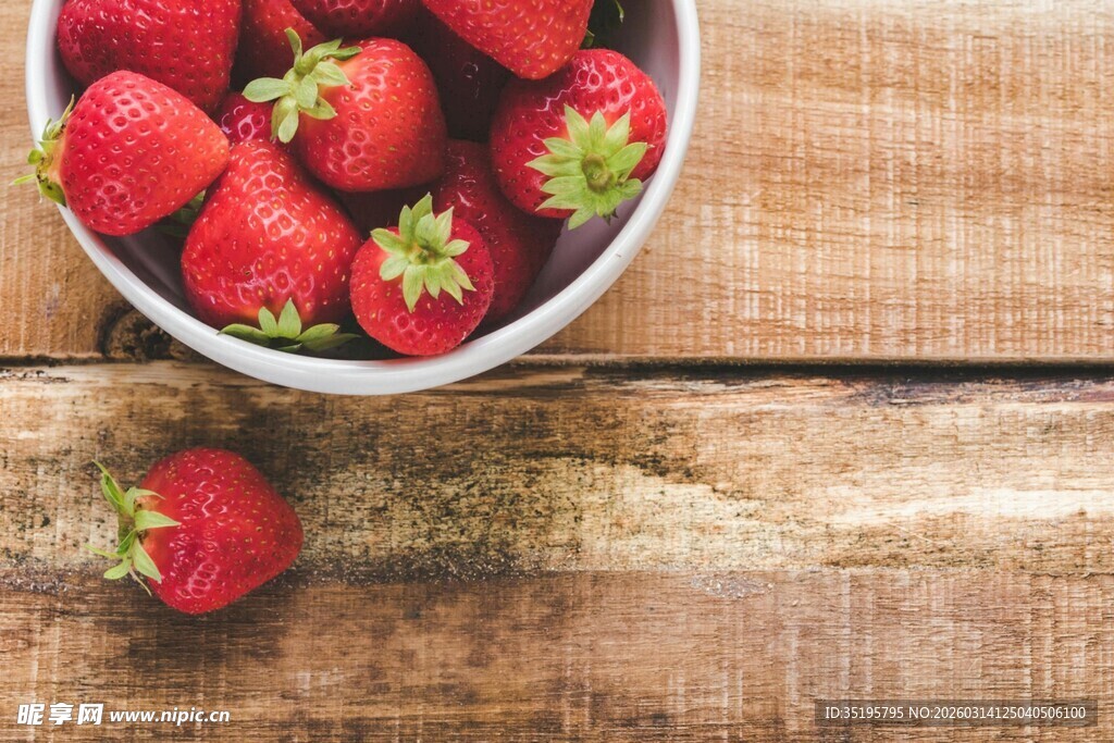 木桌上碗里的新鲜草莓
