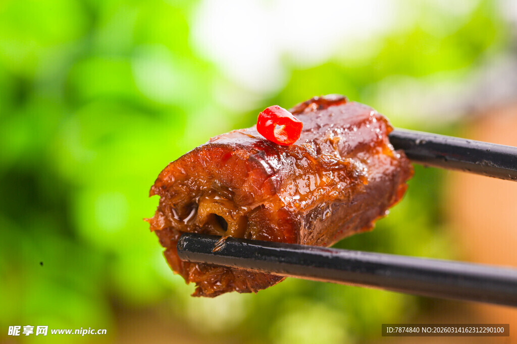 筷子夹起的美味卤鸭脖