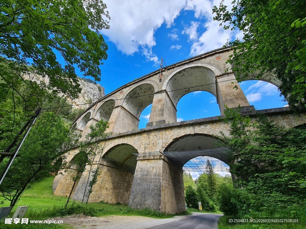 古老石拱桥横跨绿意林间