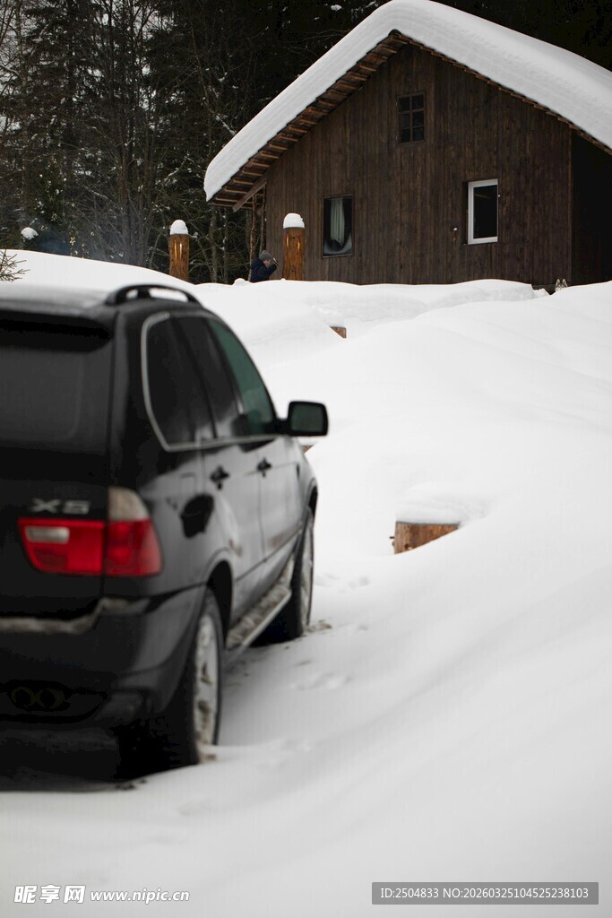 雪后小屋旁的黑色汽车