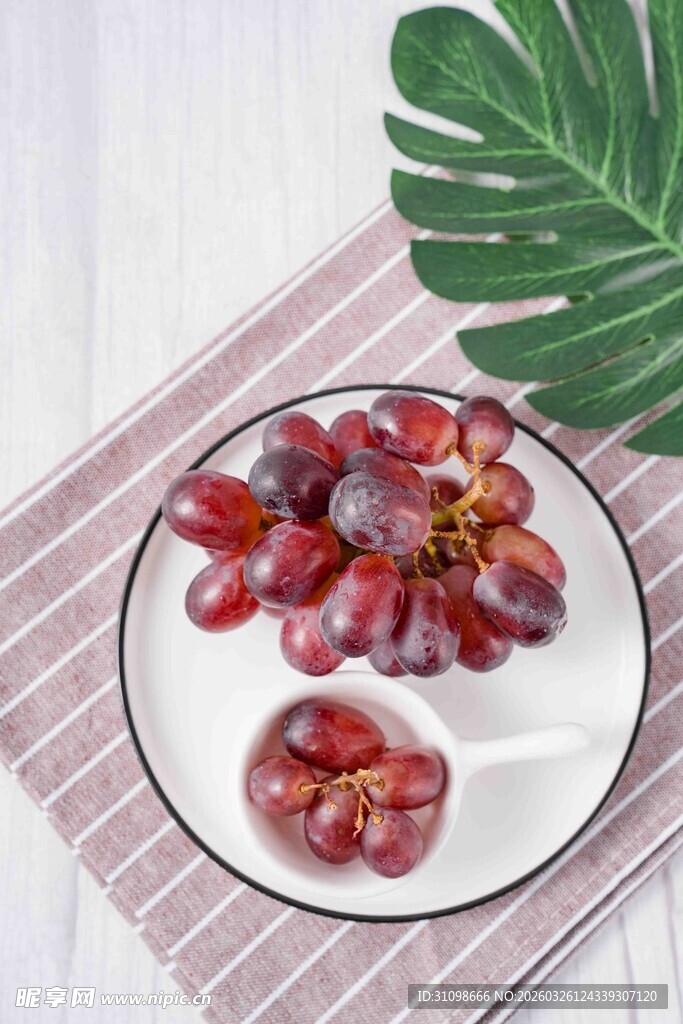新鲜紫红葡萄摆于盘上