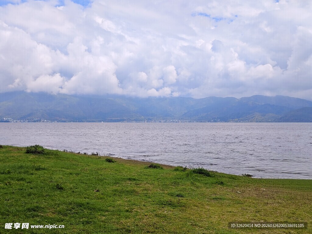湖畔草地与远处山水景致