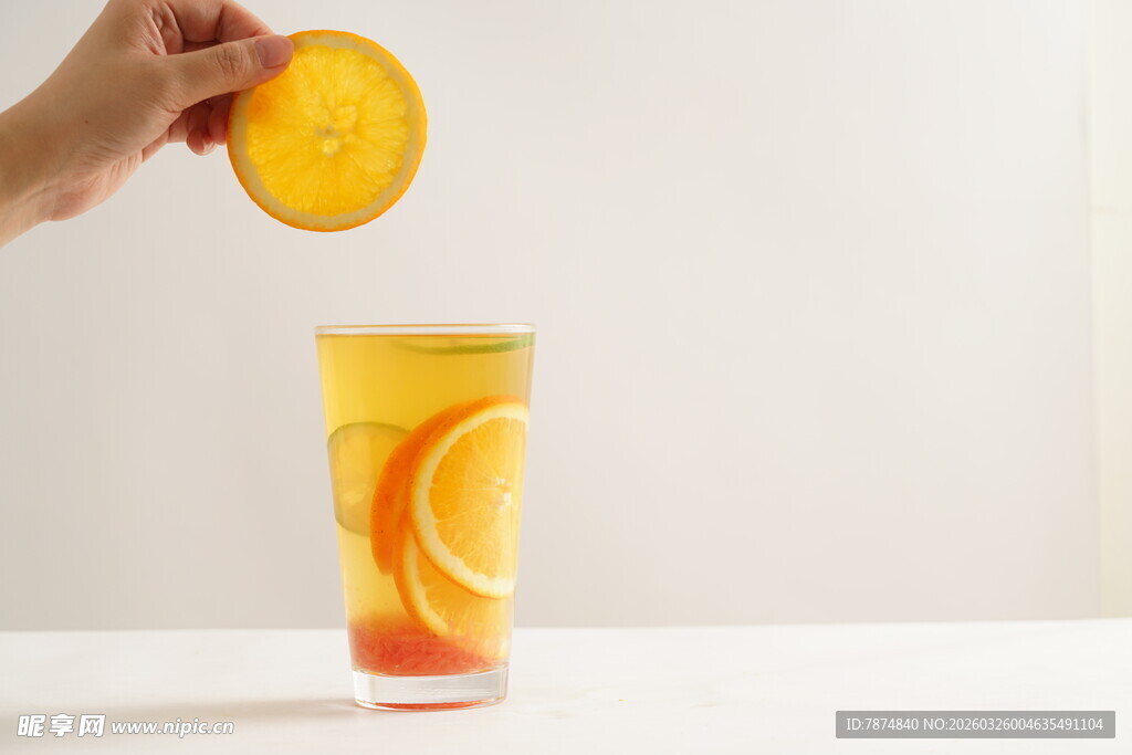 手抛橙片入果汁杯中