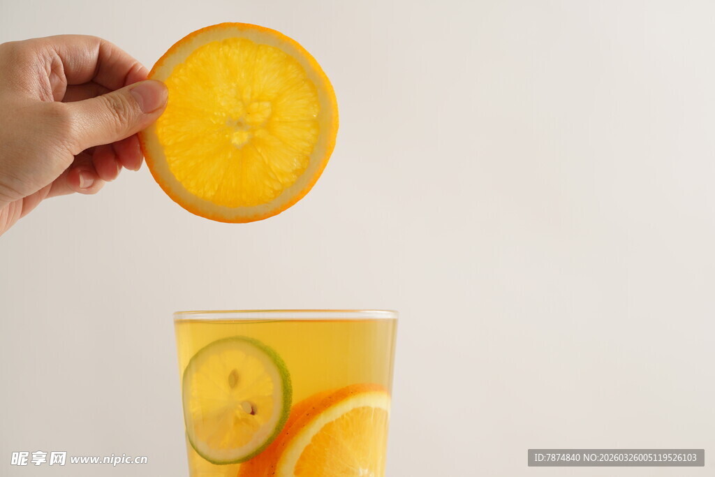 手放橙片入柠檬橙味饮品
