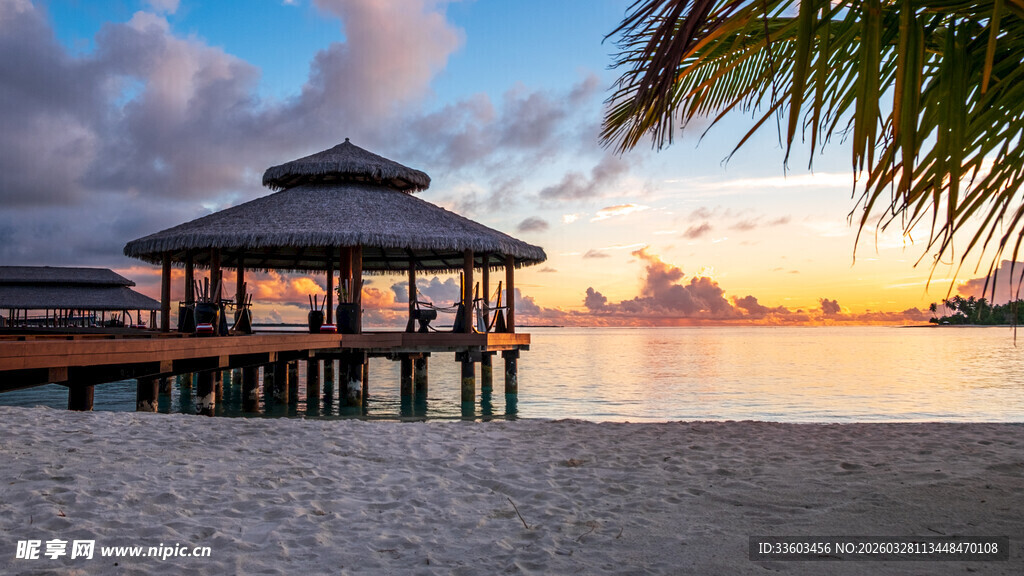 海滨日落时的水上凉亭