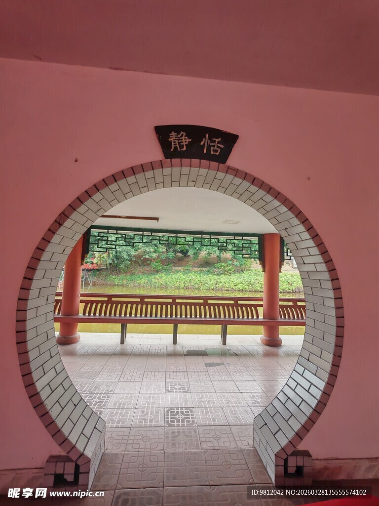 中式圆拱门后的园林景致