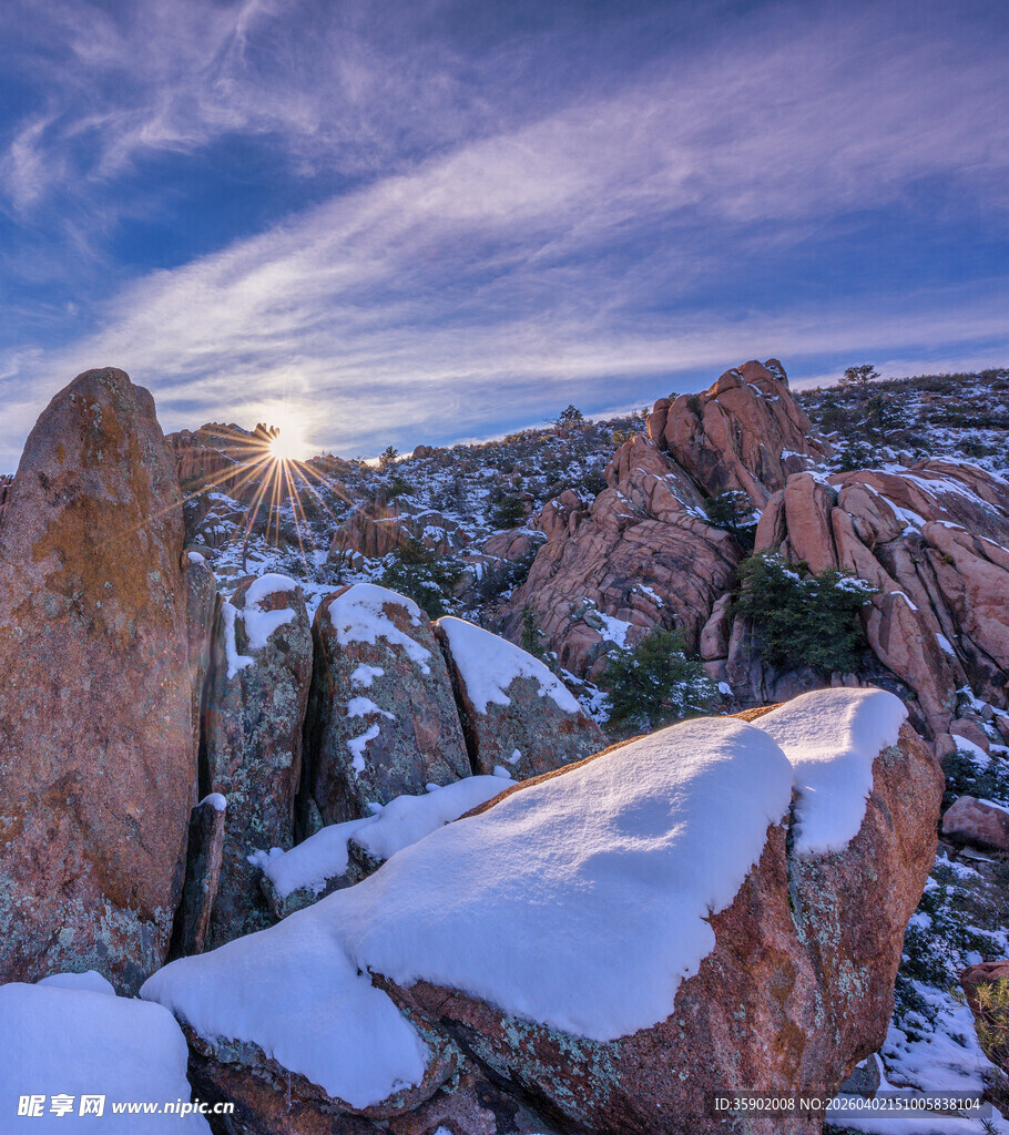 雪覆岩石间的壮丽日出