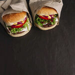 两份美味汉堡置于深色背景