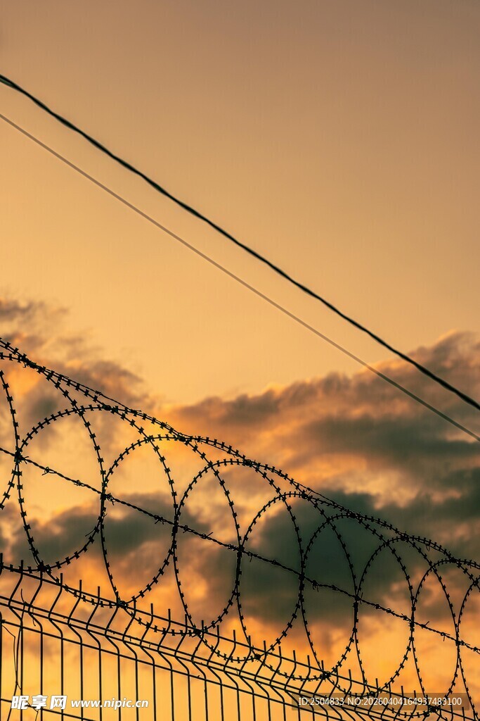 夕阳下的带刺铁丝网