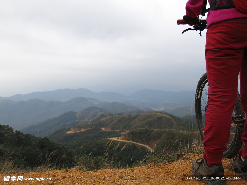 女子骑行于山间远眺美景