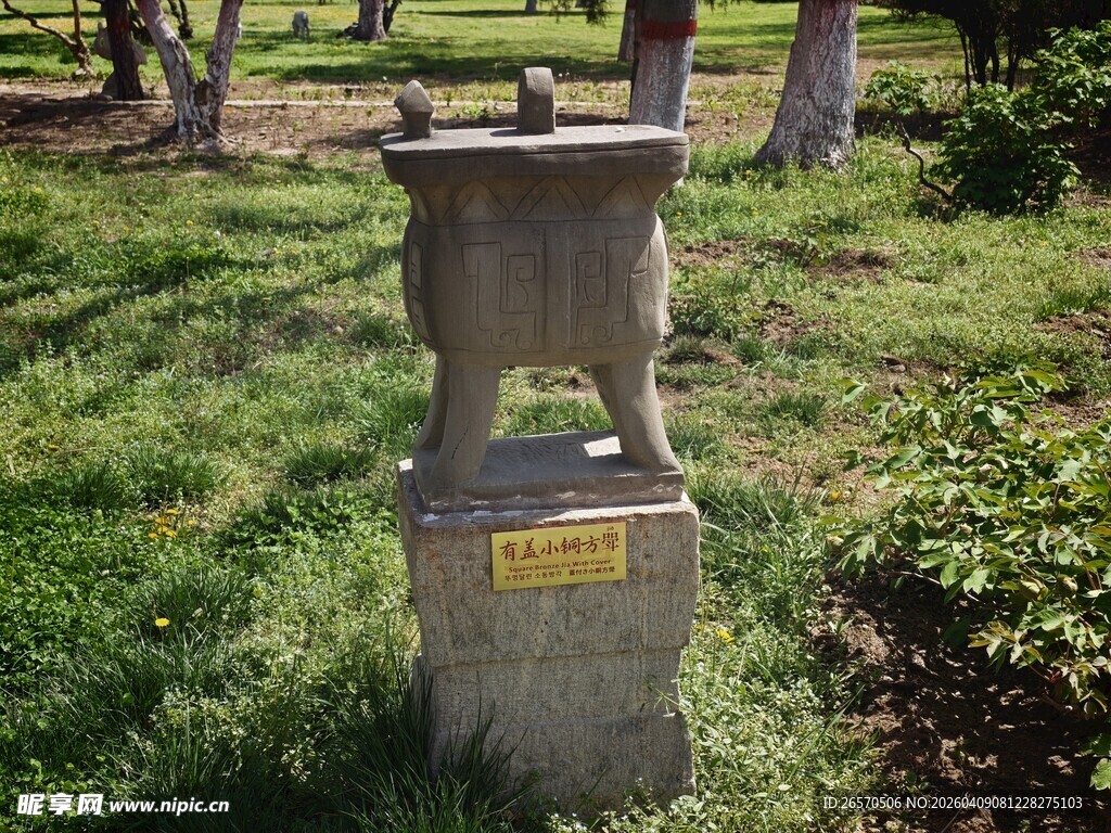 户外古朴石鼎置于绿地